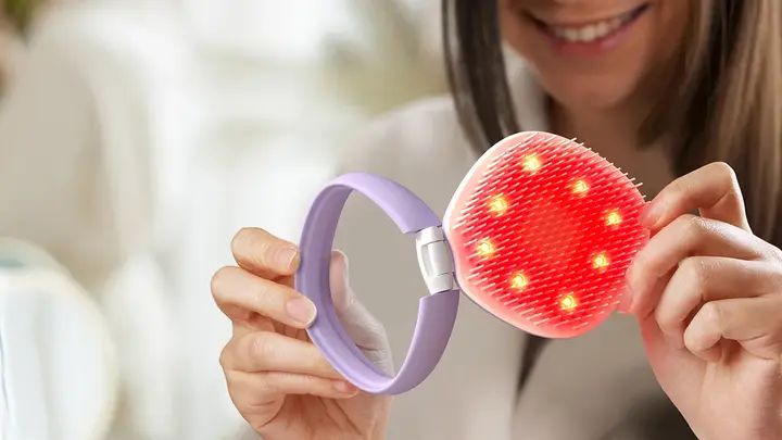 A woman opening FLIP™ play Advanced LED Light Hairbrush